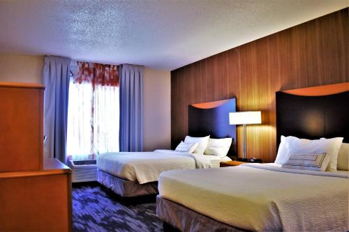 a hotel room with two beds and a window at Fairfield Inn and Suites by Marriott Strasburg Shenandoah Valley in Strasburg