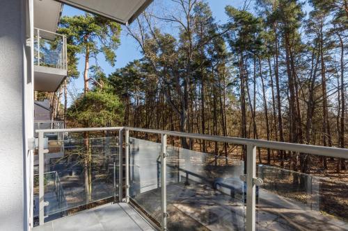 a balcony with a view of trees at 3-bedroom Apartment - Lesne Tarasy by Renters Prestige in Dziwnówek
