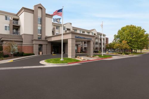 a building with an american flag on a street at Residence Inn by Marriott Salt Lake City Downtown in Salt Lake City