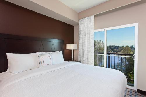 um quarto com uma cama grande e uma janela grande em Residence Inn by Marriott Seattle Sea-Tac Airport em SeaTac