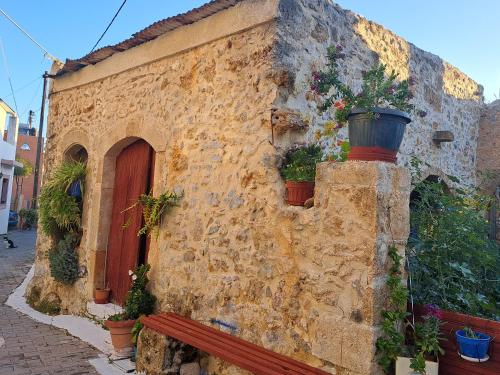 a stone building with a bench in front of it at Stella Apartments Malia in Malia