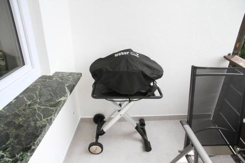 a black chair sitting next to a wall at Apartment Panoramablick 2 in Böbrach