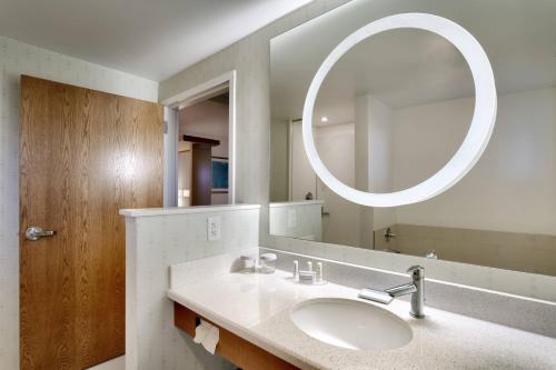 a bathroom with a sink and a mirror at SpringHill Suites by Marriott Rexburg in Rexburg