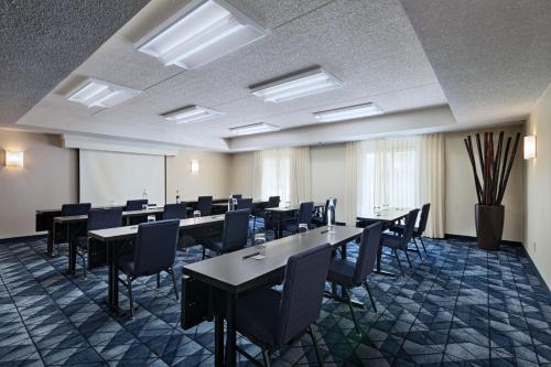 a conference room with tables and chairs and a whiteboard at Courtyard by Marriott San Antonio Downtown in San Antonio