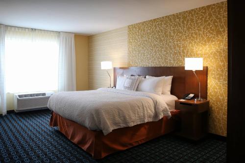 a hotel room with a bed and a window at Fairfield Inn & Suites by Marriott Madison Verona in Verona
