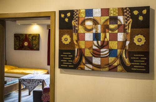a painting of a face hanging on a wall at Boardinghouse Remchingen Baan Arun in Remchingen
