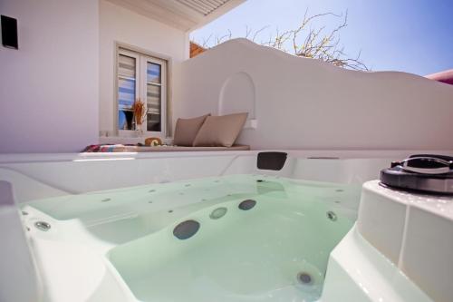 a bathtub in a white room with at Λωνη in Aggelika