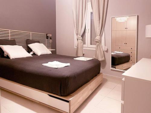 a bedroom with a large bed and a mirror at Cozy Apartment in Korydallos in Piraeus