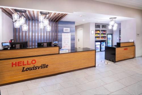 a hotel lobby with a hello louisville counter at TownePlace Suites by Marriott Louisville Downtown in Louisville