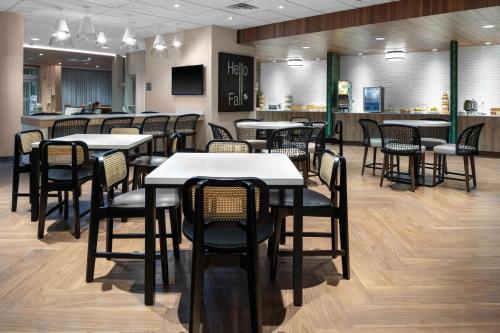Fairfield Inn & Suites by Marriott Winnemucca في وينيموكا: مطعم بطاولات وكراسي وبار
