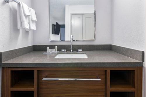 a bathroom with a sink and a mirror at Courtyard Tallahassee North/I-10 Capital Circle in Tallahassee