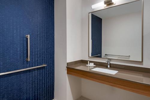 a bathroom with a sink and a mirror at Fairfield Inn & Suites Charlotte Monroe in Monroe