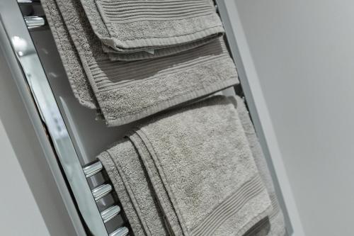 a row of towels sitting in a drawer at Rooms at Rolleston in Rolleston