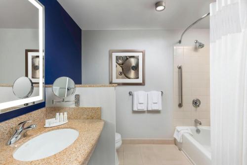 a bathroom with a sink and a tub and a toilet at Courtyard Austin Downtown/Convention Center in Austin