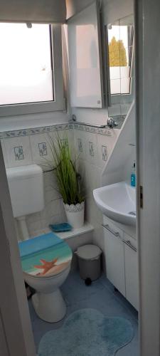 a bathroom with a toilet and a sink at Cosy Home in Scharbeutz