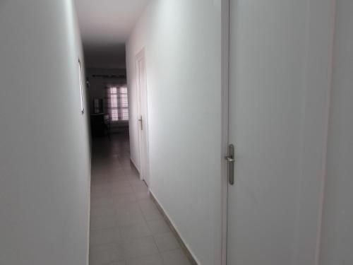an empty hallway with white walls and a door at MOJACAR HOME AND BEACH in Mojácar