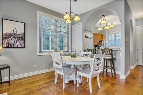 a kitchen and dining room with a white table and chairs at WALK IN Two bed Lakeview at Indian Point in Branson