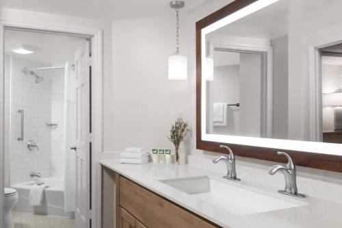 a white bathroom with a sink and a mirror at Marriott's Heritage Club in Hilton Head Island