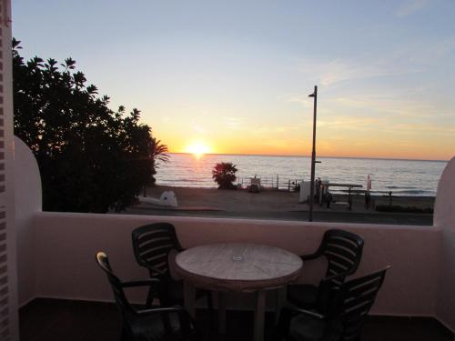 a table and chairs with a view of the ocean at MOJACAR HOME AND BEACH in Mojácar