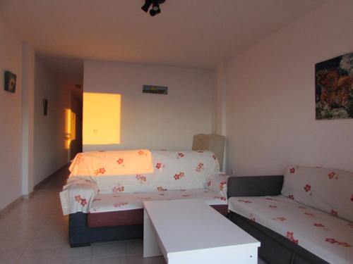 a living room with a couch and a table at MOJACAR HOME AND BEACH in Mojácar