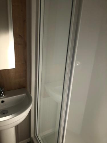a bathroom with a shower and a sink at Stylish 3 Bedroom caravan near the Beach in Walton-on-the-Naze