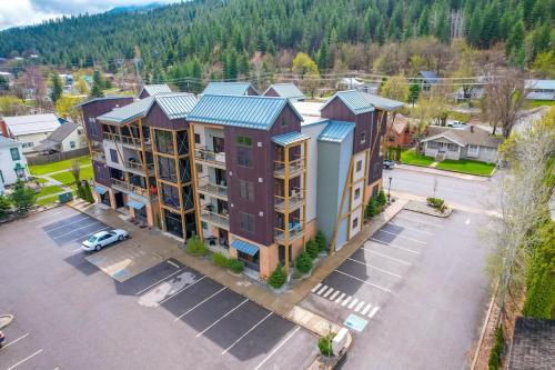 an aerial view of a apartment complex with a parking lot at Large Studio Condo with Full Kitchen, Ski, Bike, Beautiful Balcony Views Hottub Fireplace in Kellogg