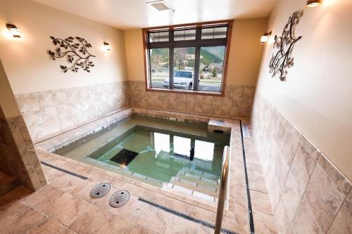 a large pool of water in a room with at Large Studio Condo with Full Kitchen, Ski, Bike, Beautiful Balcony Views Hottub Fireplace in Kellogg