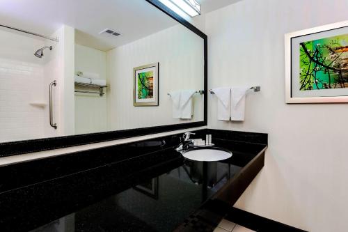 a bathroom with a sink and a mirror at Fairfield by Marriott Wilkes-Barre in Wilkes-Barre
