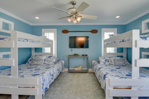 a bedroom with two bunk beds and a ceiling fan at Grand Destin Getaway - Walk a Block to the Beach! in Destin