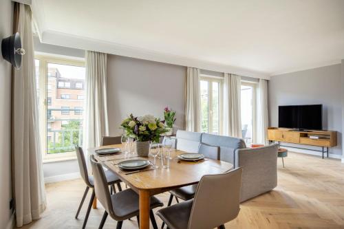 a dining room with a table and chairs at Marriott Executive Apartments Brussels in Brussels