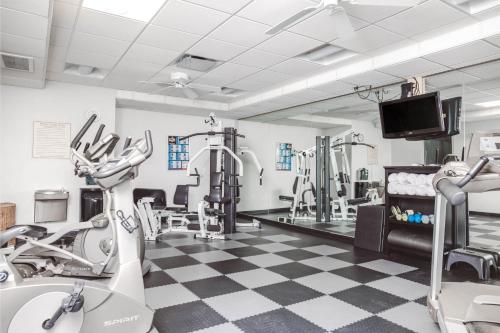 a gym with treadmills and machines in a room at The Inn On Sheridan in Zion