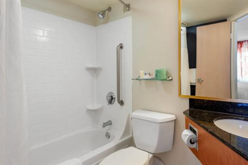 a white bathroom with a toilet and a sink at Fairfield by Marriott Inn & Suites Portland Maine Airport in Scarborough