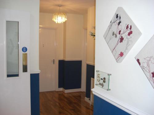 un pasillo con una habitación con chimenea y una lámpara de araña en Lynebank House Hotel, Bed & Breakfast, en Carlisle