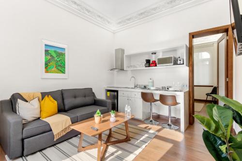 a living room with a couch and a table at Casa Arcos Chapultepec in Mexico City