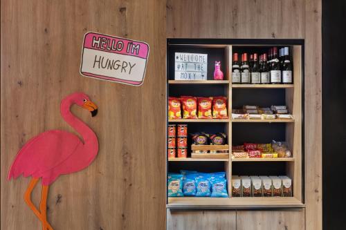 a store with a pink flamingo in front of a refrigerator at Moxy Amiens in Amiens
