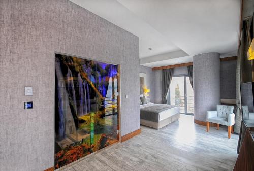 a bedroom with a large painting on the wall at Elite Hotels Darica Spa & Convention Center in Gebze
