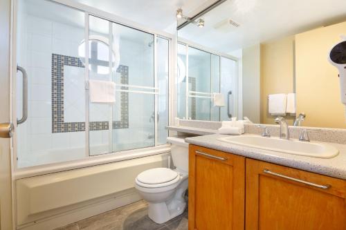 a bathroom with a toilet and a sink and a shower at Whistler Village Centre by LaTour Hotels and Resorts in Whistler