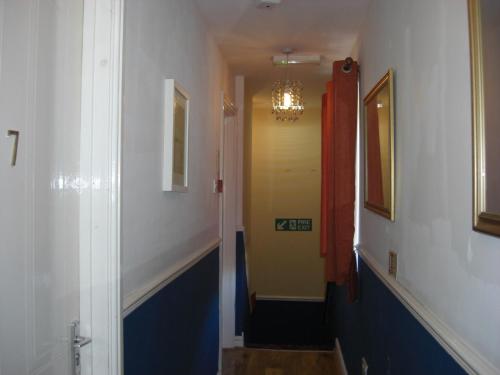a hallway with a yellow door and a yellow wall at Lynebank House Hotel, Bed & Breakfast in Carlisle