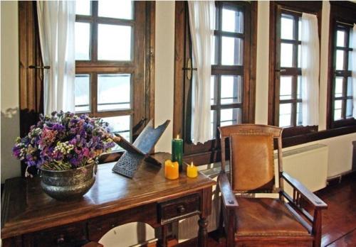 a table with a vase of flowers on top of it at Vergoula's Mansion in Kastoria
