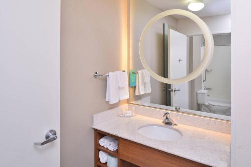 a bathroom with a sink and a mirror at SpringHill Suites Las Vegas Henderson in Las Vegas