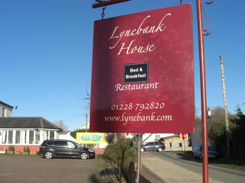 a red sign on the side of a street at Lynebank House Hotel, Bed & Breakfast in Carlisle