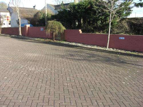 a cobblestone street with a fence and a brick road at Lynebank House Hotel, Bed & Breakfast in Carlisle
