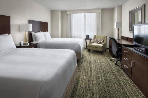 a hotel room with two beds and a flat screen tv at Philadelphia Airport Marriott in Philadelphia