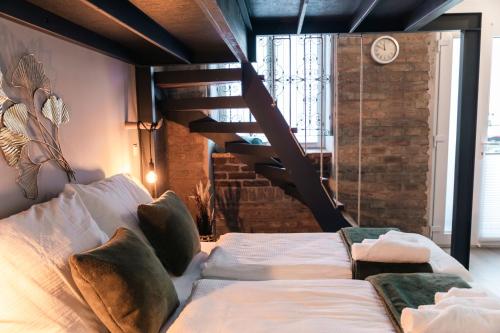 a bedroom with a bed and a spiral staircase at MADU-Living Vienna - Egon in Vienna