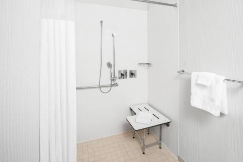 a white bathroom with a sink and a shower at Courtyard Bowling Green Convention Center in Bowling Green