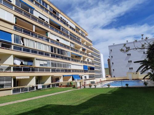 een groot appartementencomplex met een gazon ervoor bij NEW Palacio del Sol Torremolinos in Torremolinos