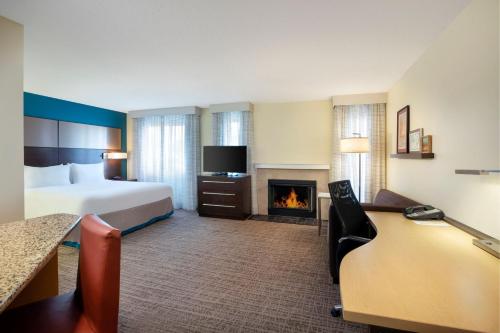 a hotel room with a bed and a fireplace at Residence Inn Bakersfield in Bakersfield