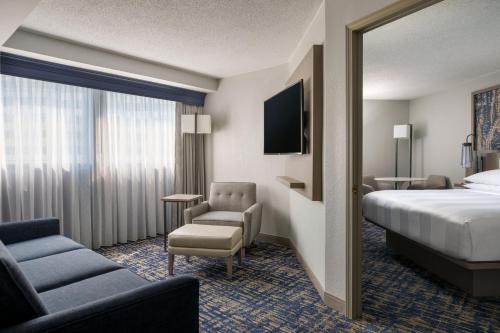 a hotel room with a bed and a chair at Marriott Columbia in Columbia