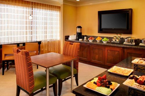 a hotel room with a table and a television at Marriott Columbia in Columbia