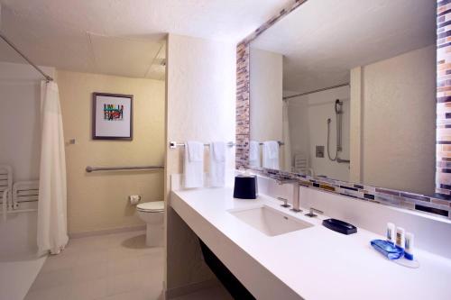 ein Badezimmer mit einem Waschbecken, einem WC und einem Spiegel in der Unterkunft Fairfield Inn & Suites by Marriott Key West in Key West
